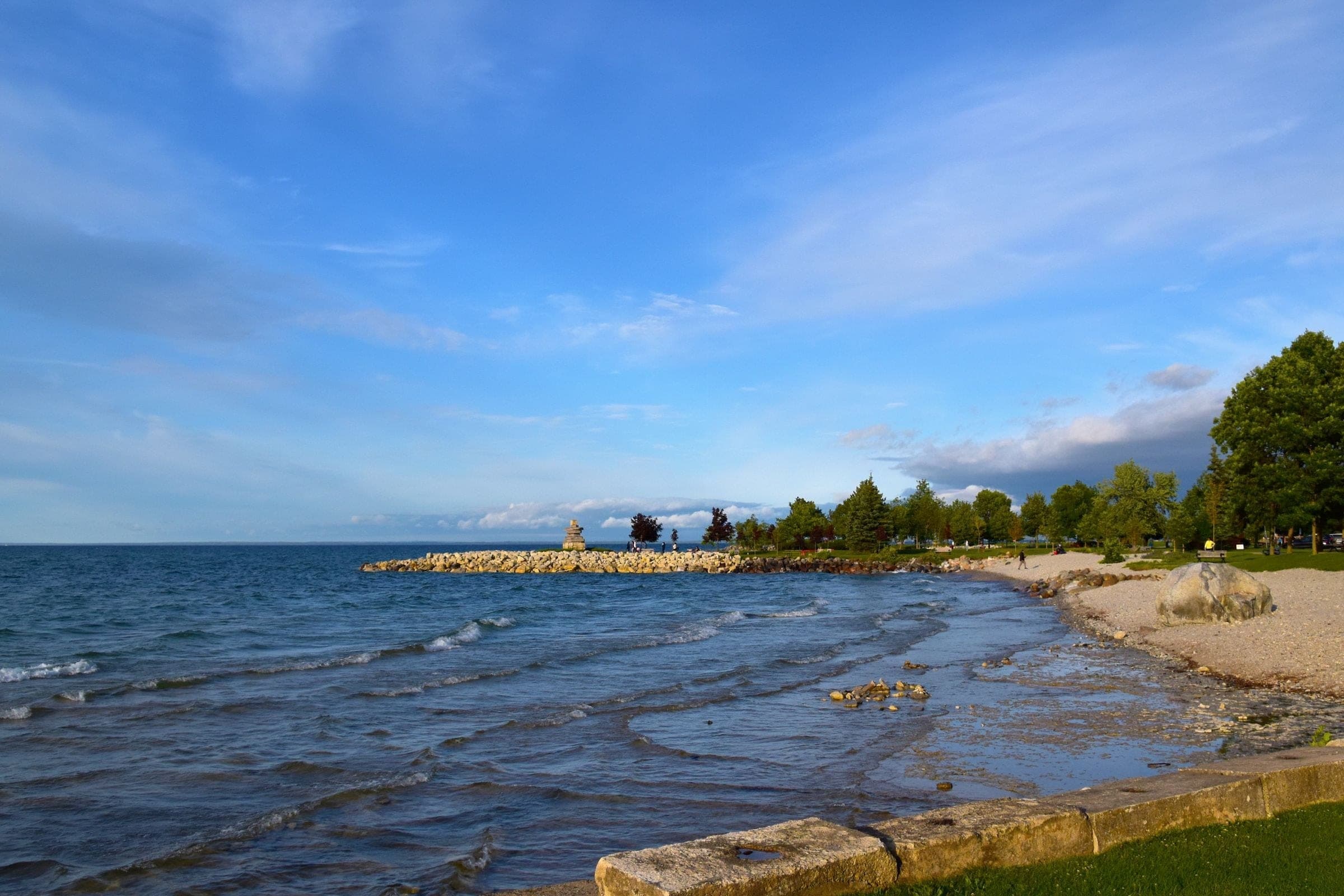 Lake Ontario shoreline with a stone breakwater and a beach park